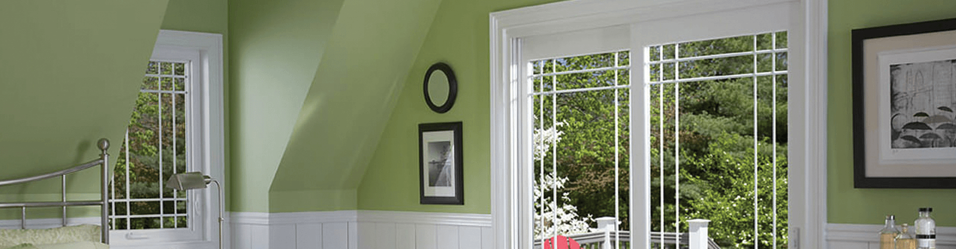 Newly-installed windows in a green and white bedroom.