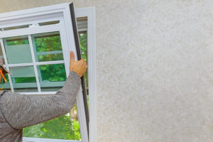Worker installing new window in a house